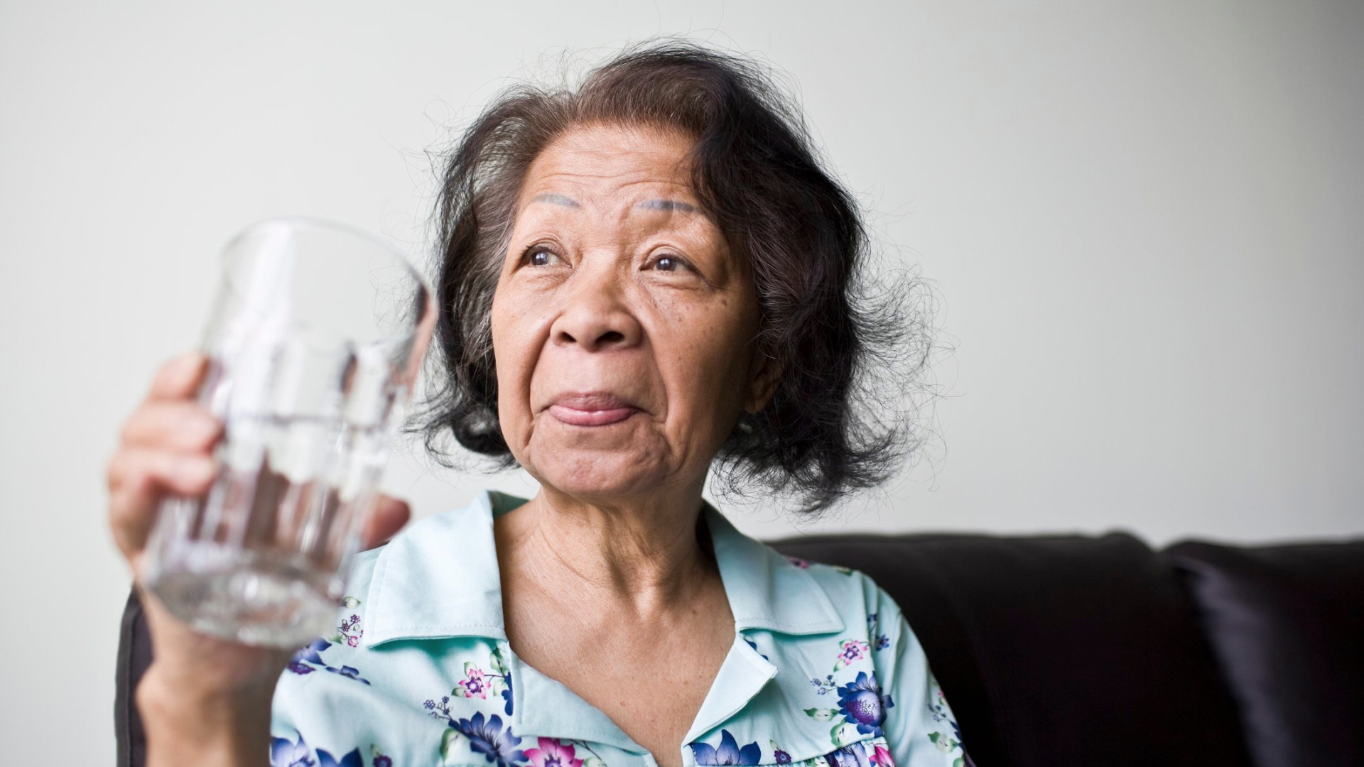 Senior woman holding a glass of water